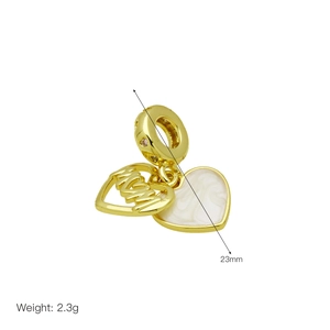 Detailed view of a gold heart charm with white enamel MOM lettering and 23mm height