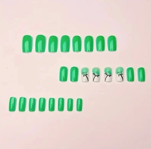Detailed set of green press-on nails featuring hand-painted dandelion floral art designs