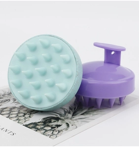 Close-up of 19-tooth silicone scalp massage brush with ergonomic handle and soft bristles