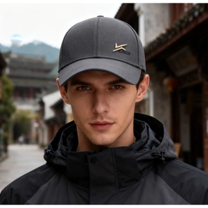 Detail of grey baseball cap featuring premium gold embroidery on durable canvas fabric