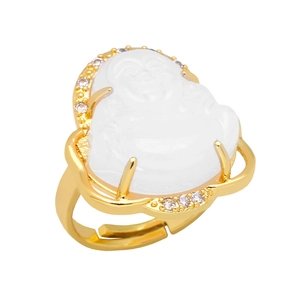 Macro detail of golden Laughing Buddha ring with white stone and sparkling zircon accents