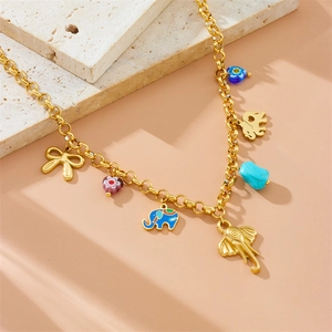 Detail of gold chain necklace with enamel elephant pendants and turquoise stones