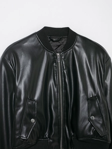 Detail of black faux leather bomber jacket showing metal zipper and ribbed collar texture