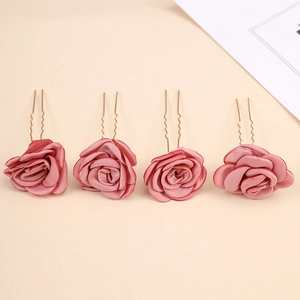 Detailed view of four pink satin rose U-shaped bridal hair pins with gold metal finish
