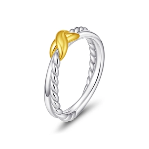 Two-tone stainless steel cable ring with golden X crossover knot at a 45-degree angle