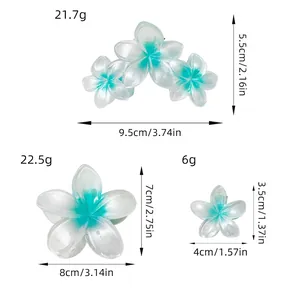 Gradient plumeria flower hair claws in multiple sizes for trendy styling and strong grip