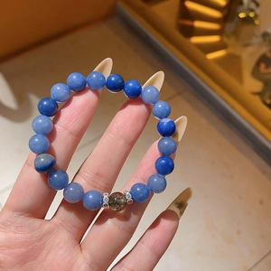Detail of blue zircon beaded bracelet showing polished stones and silver spacer beads