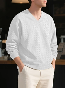 Close-up of white V-neck cable knit sweater with detailed texture and ribbed collar