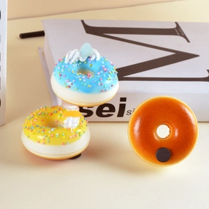 Realistisches Donut-Magnet-Set mit buntem Guss und starkem Magneten auf weißem Buch