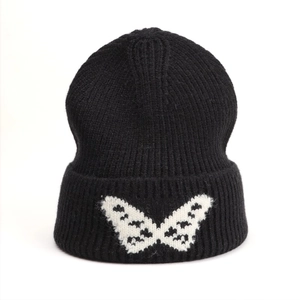 Winter black knit beanie with white butterfly jacquard pattern and folded cuff design