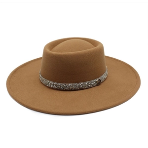 Detail of camel wool felt fedora featuring a rhinestone band and gold M logo