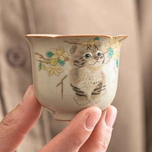 Ru-kiln ceramic teacup with hand-painted cat and flower patterns on a beige glazed surface