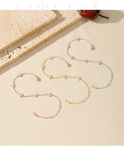 Three dainty clover bracelets in silver, gold and rose gold finishes with crystals