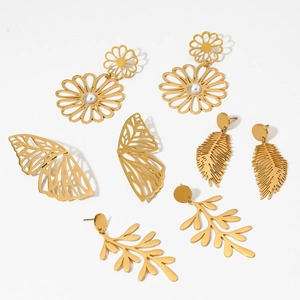 Detailed view of four pairs of gold-plated hollow earrings in leaf, butterfly, and flower shapes