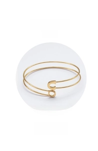 Detail view of gold Z206 double coil bracelet with C and O letter charms on white background