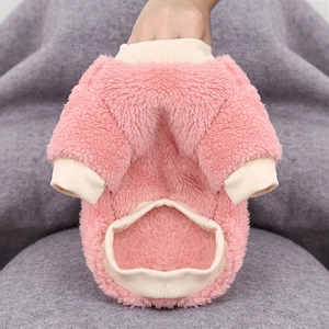 Close-up of pink fleece dog clothing featuring white ribbed trim and soft texture
