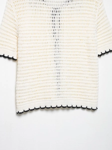Detail of crochet knit top with contrast wave edges and hollow-out mesh texture