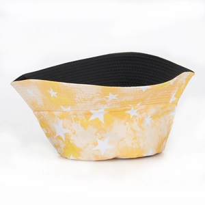 Close-up of yellow tie-dye bucket hat with white star print and stitched brim detail