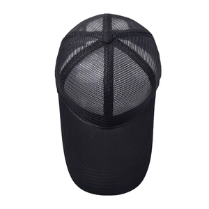 Close-up of black breathable mesh material and stitching on outdoor sports trucker hat