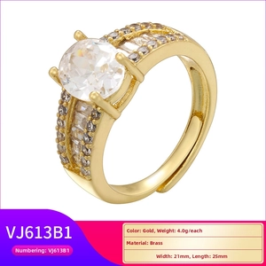 Detail of luxury gold ring with large oval clear stone and micro-pave brass band