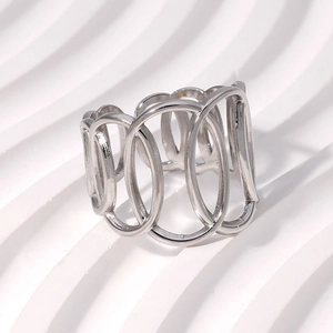 Macro shot of silver cutout stainless steel ring with oval link design on white surface