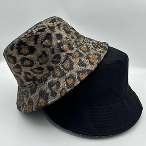 Detail view of two bucket hats in leopard print and classic black canvas texture