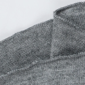 Macro shot of grey knitted fabric texture and premium stitching details on the neckline