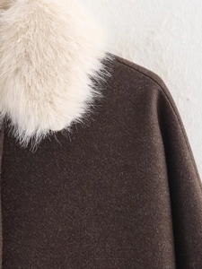Detail of soft brown wool coat with premium white faux fur collar and textured fabric weave