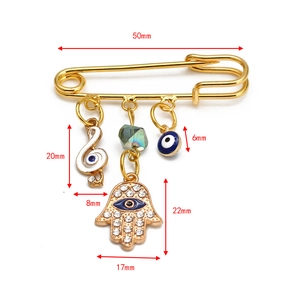 Detailed size measurement of a gold hamsa hand and evil eye brooch pin jewelry