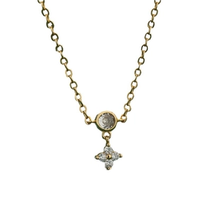 Elegant gold clover necklace with round zircon pendant and flower charms on white background