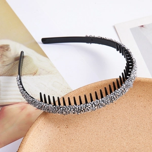 Close-up of sparkling silver rhinestones on a non-slip hairband with inner comb teeth