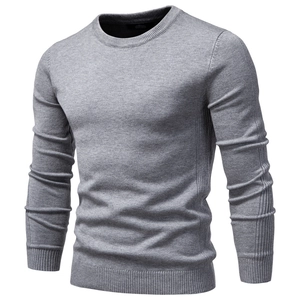 Macro detail of the gray crew neck sweater showing ribbed cuffs and fine knit texture