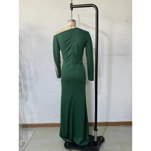 Detail of dark green evening dress with sequined neckline and elegant mermaid fishtail hem