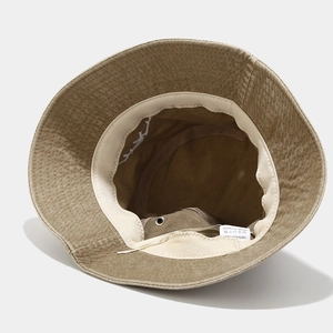Detailed view of the 100% cotton inner label and stitching on this khaki bucket hat