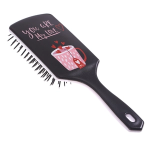 Detail of air cushion massage brush featuring pink heart patterns and love typography