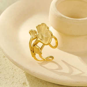 Elegant 18K gold plated stainless steel ginkgo leaf open ring on a ceramic tray