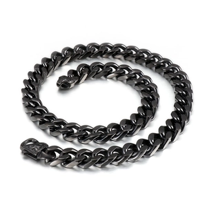 Detail of a matte black stainless steel Cuban link necklace with solid buckle design
