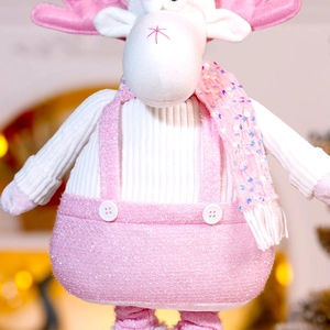 Detail of reindeer plush toy with pink sequin overalls and white knitted sweater