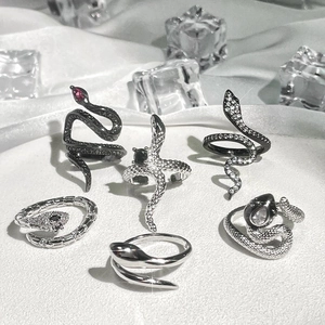 Punk style silver snake rings collection with red stones and sparkling rhinestones