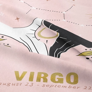 Detail of Virgo zodiac tapestry showing soft pink fabric with gold stars and moon