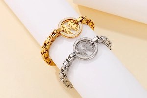 Detail view of gold and silver Byzantine chain bracelets with boy and girl pendants