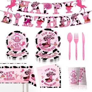 Pink cowgirl theme party supplies set with cow print plates and birthday banner