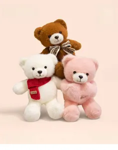Detailed view of plush teddy bears in brown, white and pink with cute scarves and bows