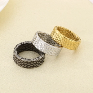 Three wide stainless steel rings in gold, silver and black with diamond cut patterns