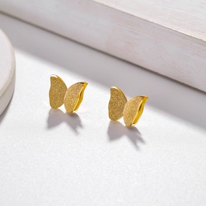 3D butterfly stud earrings in gold with matte frosted finish and polished details