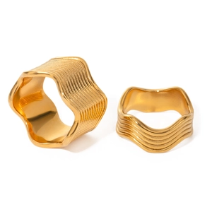 Polished gold stainless steel wide wave rings set shown on a clean white background