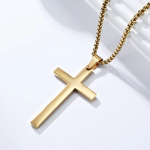 Macro shot of 18K gold-plated stainless steel cross pendant with polished box chain