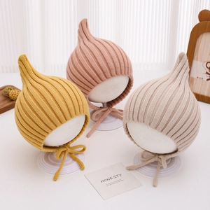 Knitted baby pixie hats with chin straps in yellow, pink and grey colors for autumn