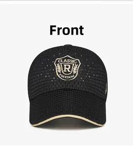 Detail of shield embroidery and breathable mesh texture on a black summer baseball cap