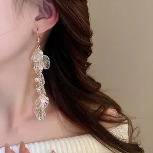 Elegant long fringe shell petal earrings with pearls and iridescent luster on model